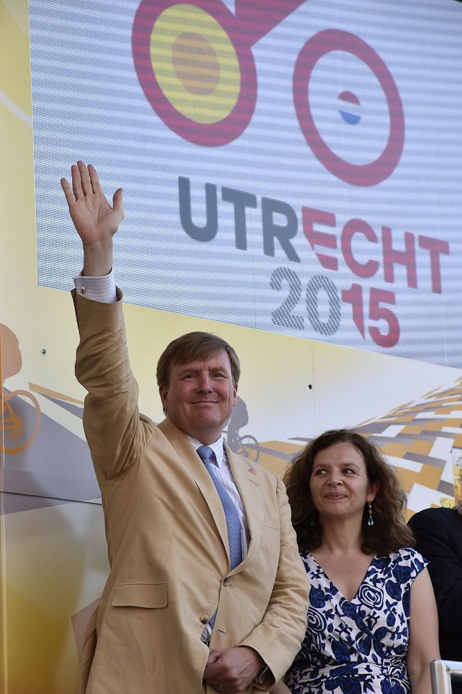 King Willem-Alexander of the Netherlands (L) waves on the podium at the end of a 13.8 km individual time-trial, the first stage of the 102nd edition of the Tour de France