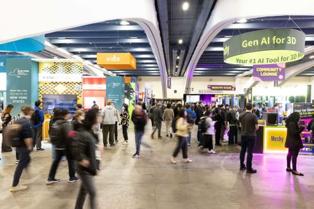 Attendees at GDC 2025 walking between expo hall booths. A sign reads "Gen AI for 3D."