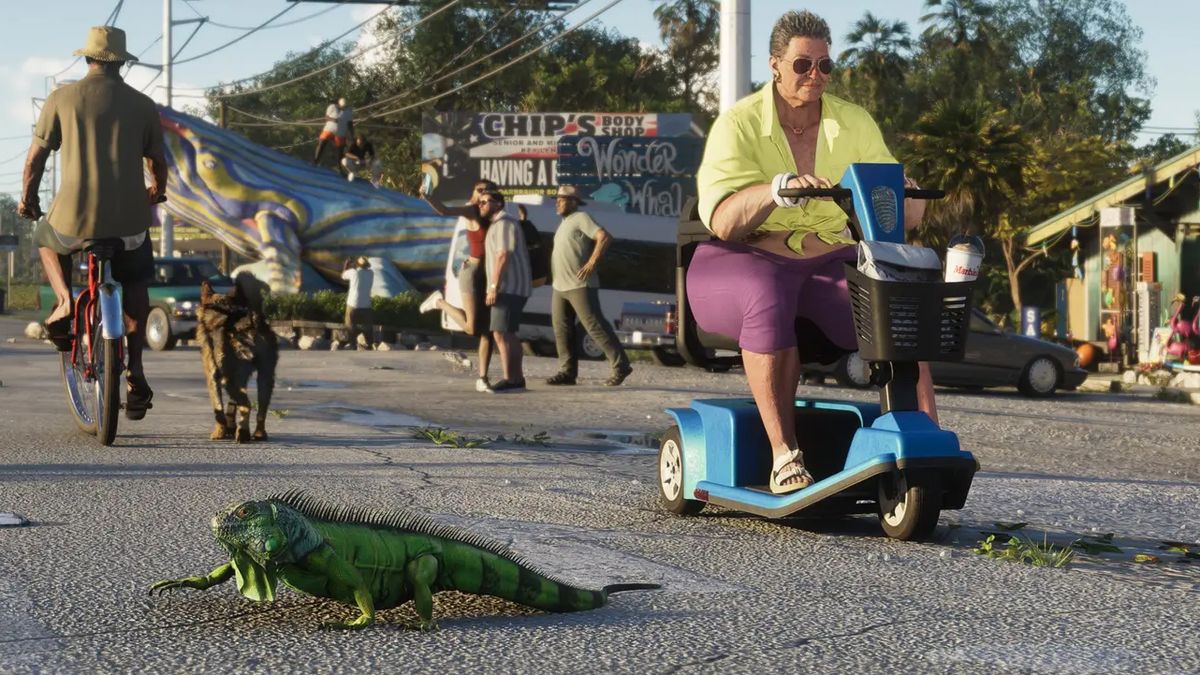 An iguana crossing a street near a woman on a scooter