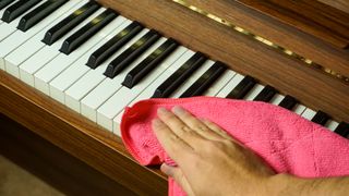Piano keys being cleaned