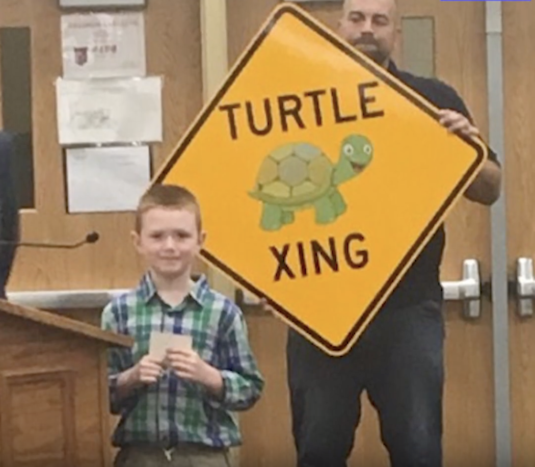 Jack Wietbrock with a &amp;quot;turtle crossing&amp;quot; sign.