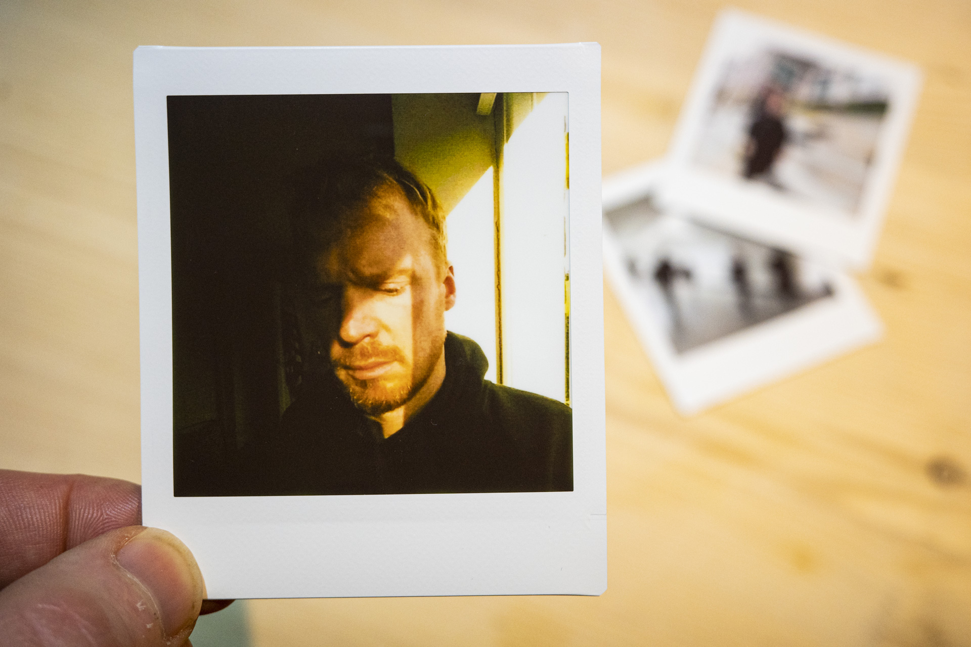 Fujifilm Instax Pal print of a self portrait on Link Square film,, in the hand