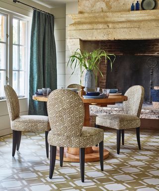checklist for modern rustic style, rustic dining room with large stone fireplace, real drapes, round dining table and upholstered chairs, patterned tile floor, shiplap walls