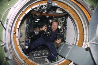 Astronaut Frank Culbertson holding the same (or similar) camera used to capture the aftermath of the 9/11 terrorist attacks in a photo taken on the International Space Station on Sept. 17, 2001.