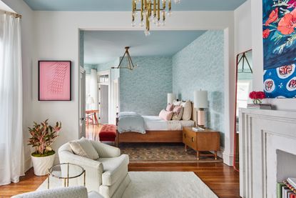 a bedroom suited with a light blue painted ceiling