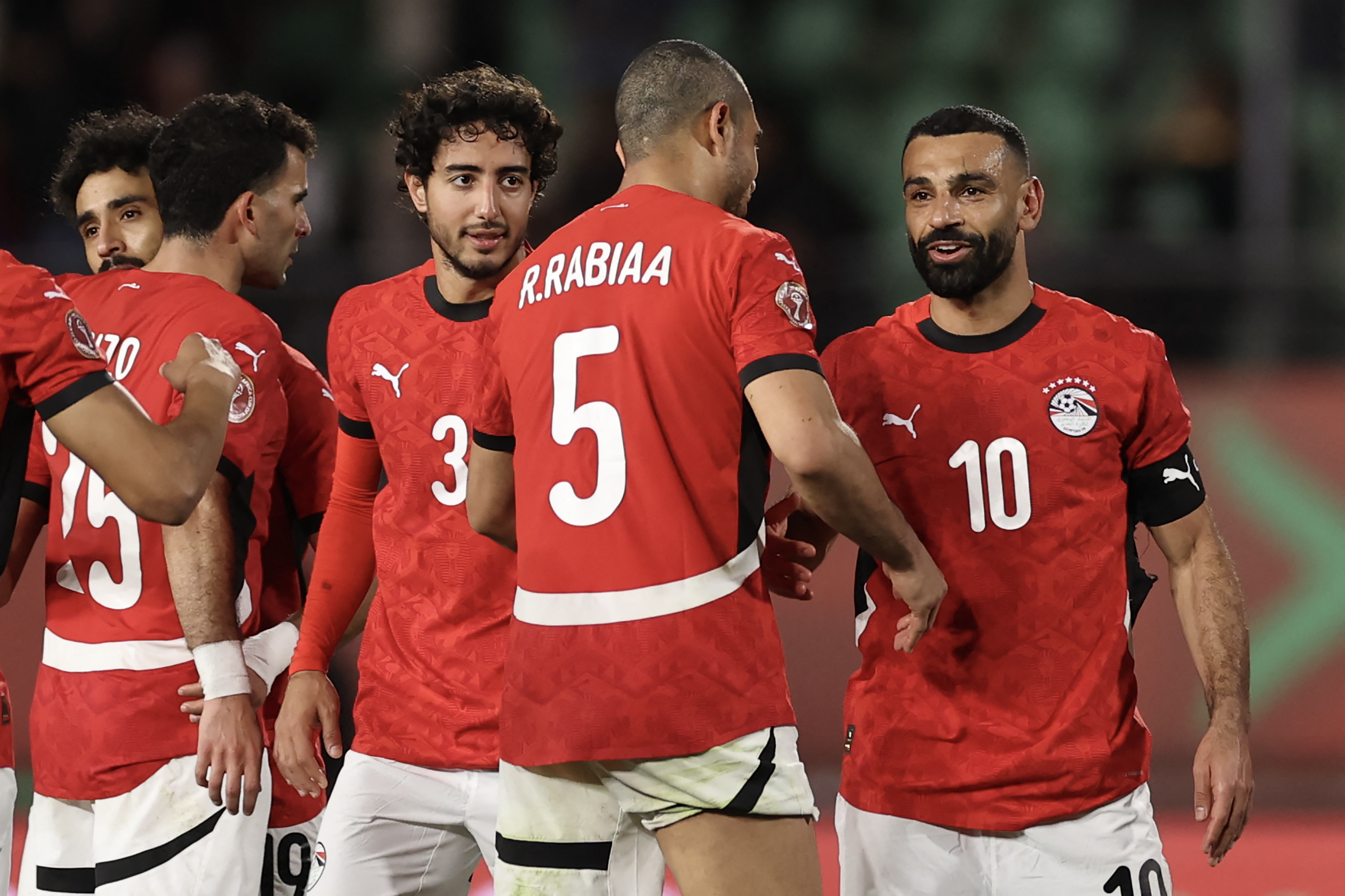 Egypt's forward #10 Mohamed Salah shakes hands with Egypt's defender #05 Ramy Rabia after the Africa Cup of Nations (CAN) round of 16 football match between Egypt and Benin at the Grand Stadium in Agadir on January 5, 2026. (Photo by FRANCK FIFE / AFP)