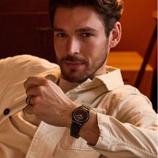 Man sitting in an armchair wearing a Bulova men's watch