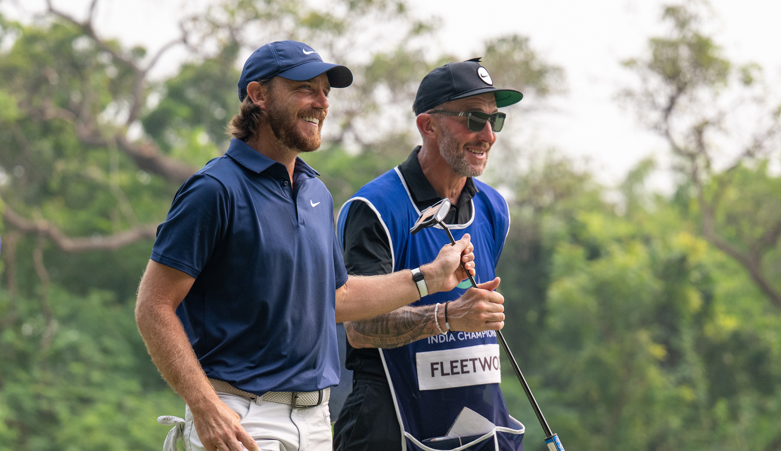 Tommy Fleetwood and his caddie walk down the fairway