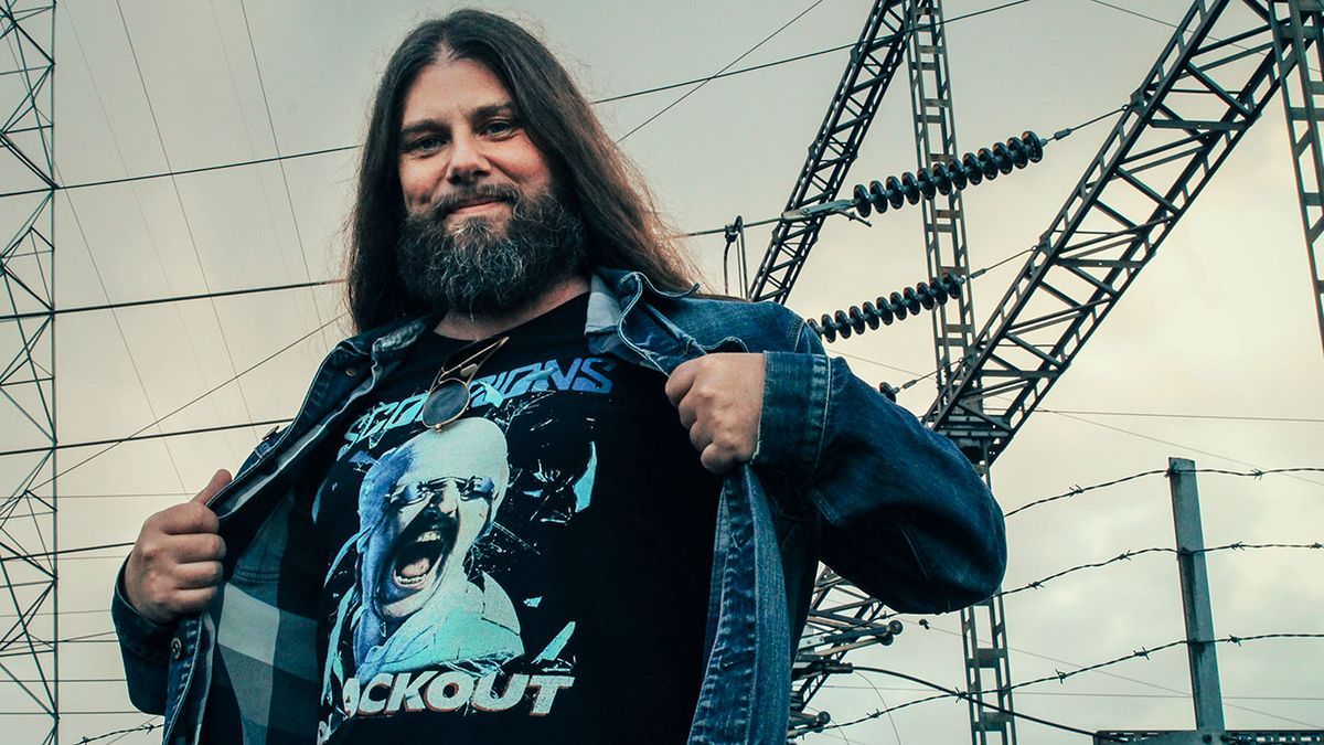 Jacob Holm-Lupo showing off his T-shirt in front of a telegraph tower