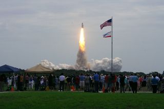 Spectators in the foreground watch as Atlantis launches on its final flight, July 8, 2011.