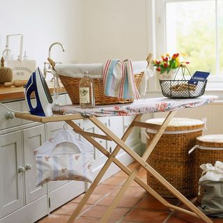 Country kitchen detail vintage style ironing board laundry basket iron bottle linen water wire basket wooden pegs