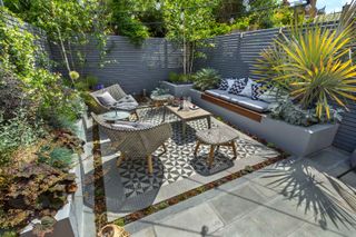 modern garden with paving and privacy fence