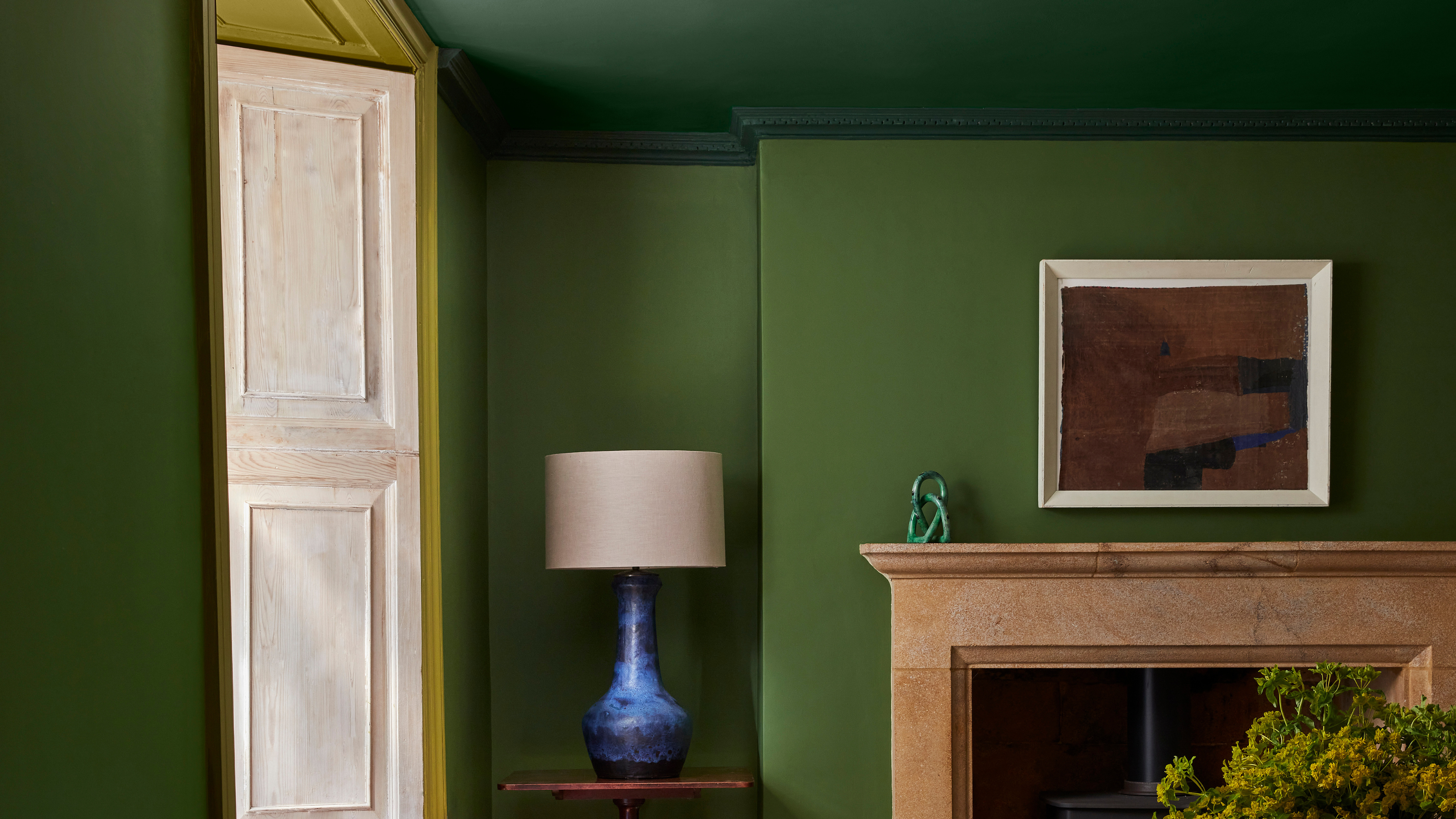 Close-up of a dining room with a green colour capped paint scheme.
