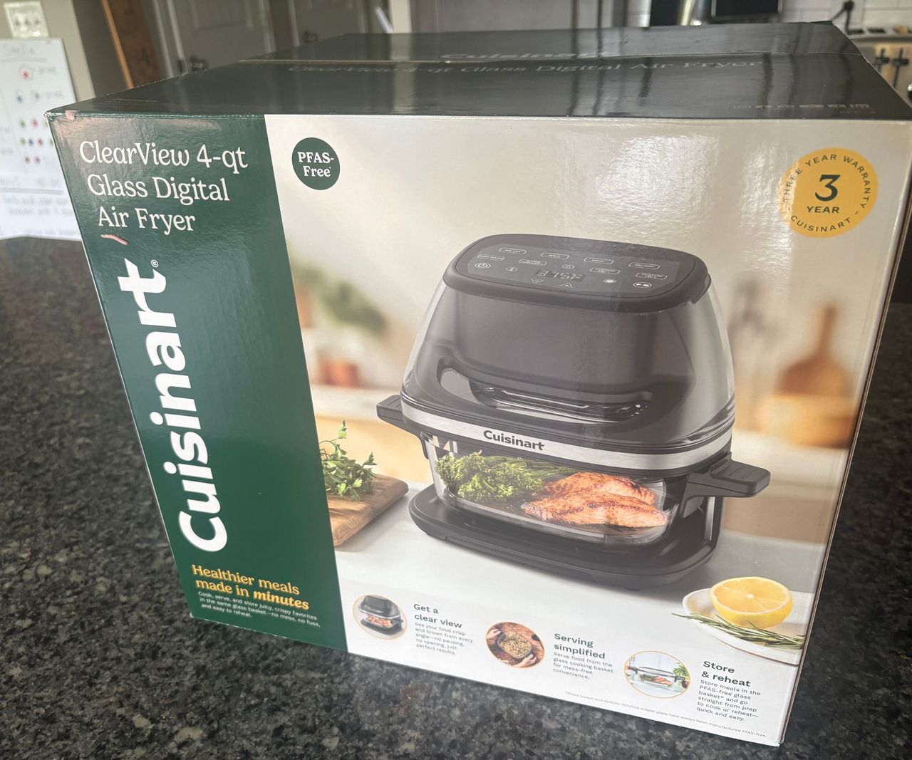 The Cuisinart glass air fryer box on a granite countertop