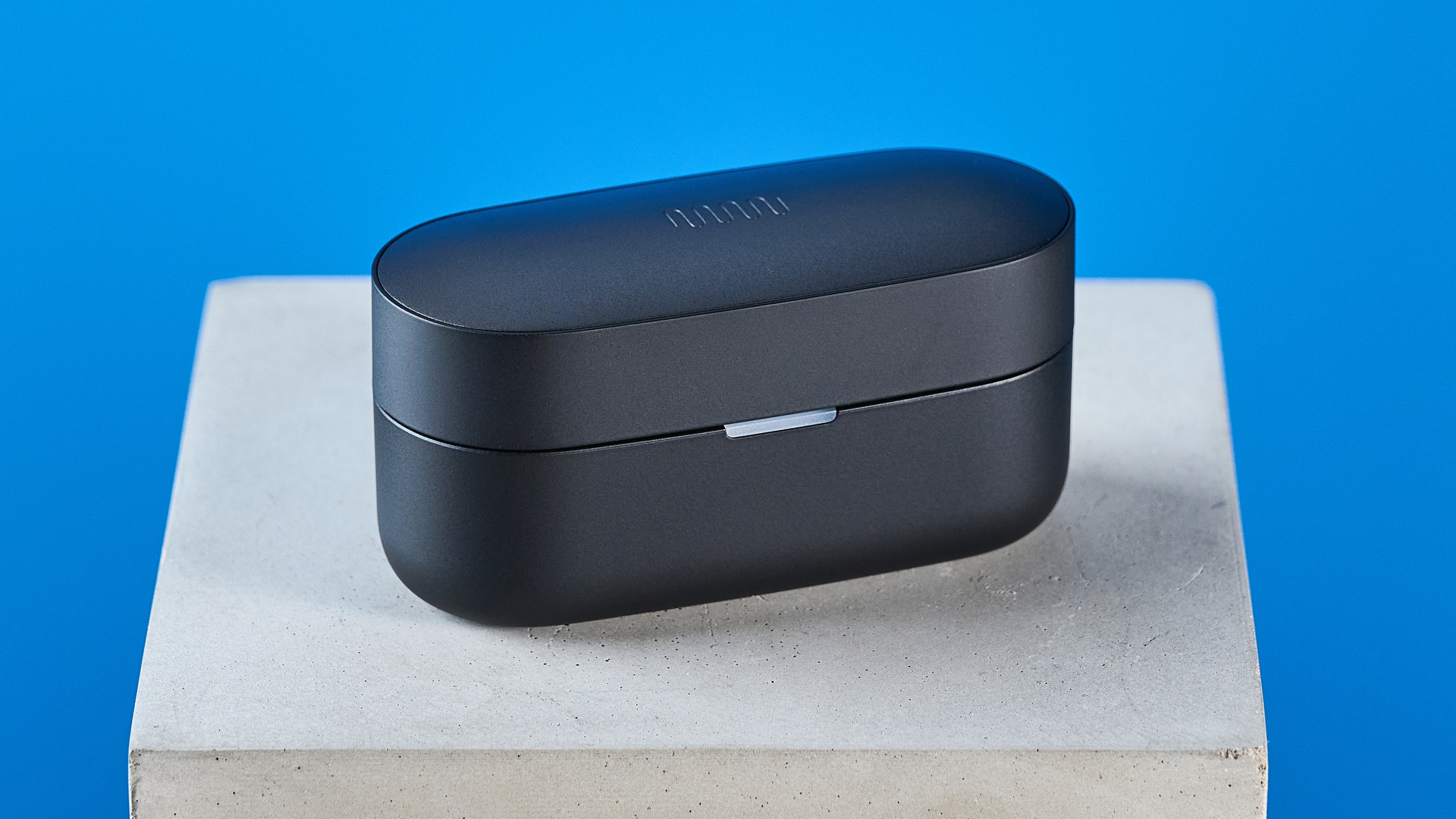 A pair of black Status Pro X wireless earbuds