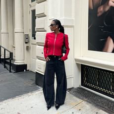 Influencer wearing a red jacket and black jeans in NYC