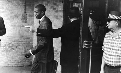 An unidentified young black 'Freedom Rider' is told to leave a segregated white waiting room at a bus depot in Jackson, Miss., May 26, 1961.