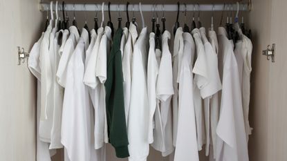 White clothes hanging in closet