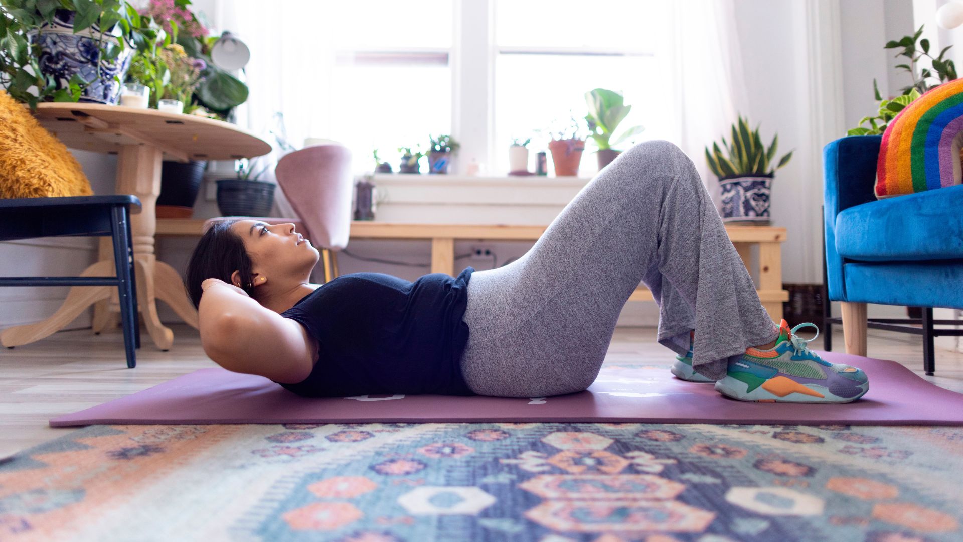 Woman doing crunches on living room floor