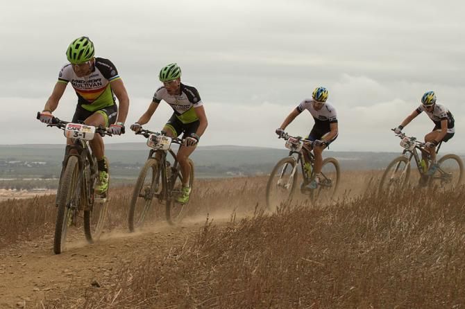 Jose Hermida and Rudi van Hout of Team Multivan Merida Biking pass Tim Boehme and Simon Stiebjahn of Team Bulls 2 to ensure they win the Prologue