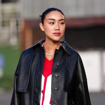 best foundations for oily skin street style shot of woman in leather jacket with glowy skin