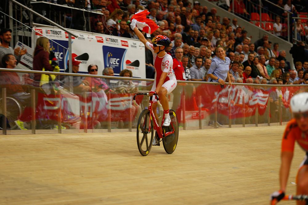Katarzyna Pawlowska (Poland) takes a victory lap after the women's points race.