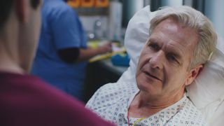 Robert Bathurst as Russell in a hospital gown and in a ward bed looking frail.