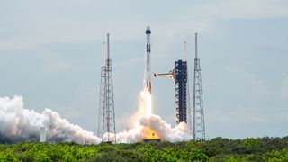 A SpaceX black and white rocket launches the Crew-9 astronaut mission for NASA.