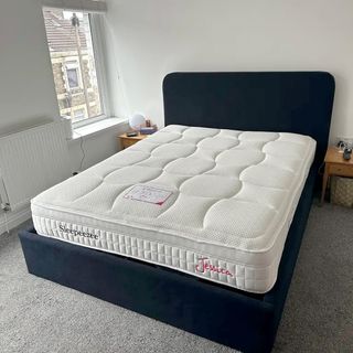 The Sleepeezee Jessica 1800 Pocket Gel mattress on a blue upholstered bed in a bedroom