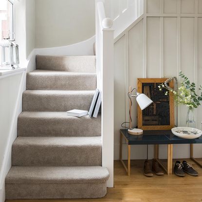 room with wooden flooring and staircase with velvet straps