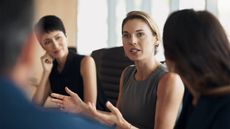 Woman talks while colleagues listen in a work meeting