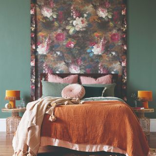 A green-painted bedroom with a floral wall tapestry