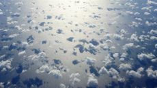 Clouds casting shadows over ocean