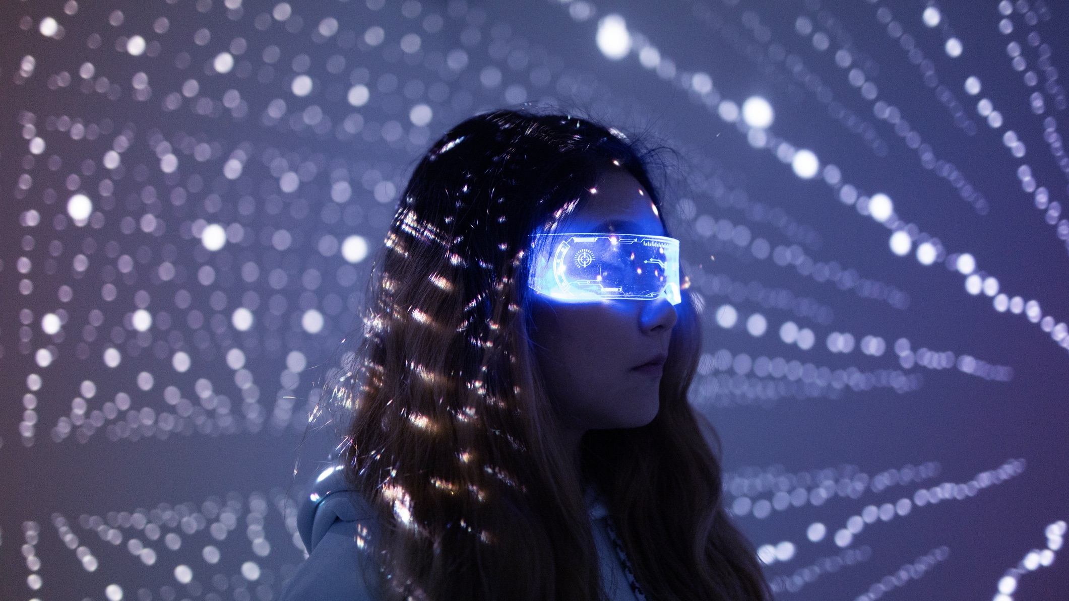 A woman wearing augmented reality smart glasses at night