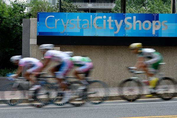Riders pass by the entrance to the underground Crystal City Shops.
