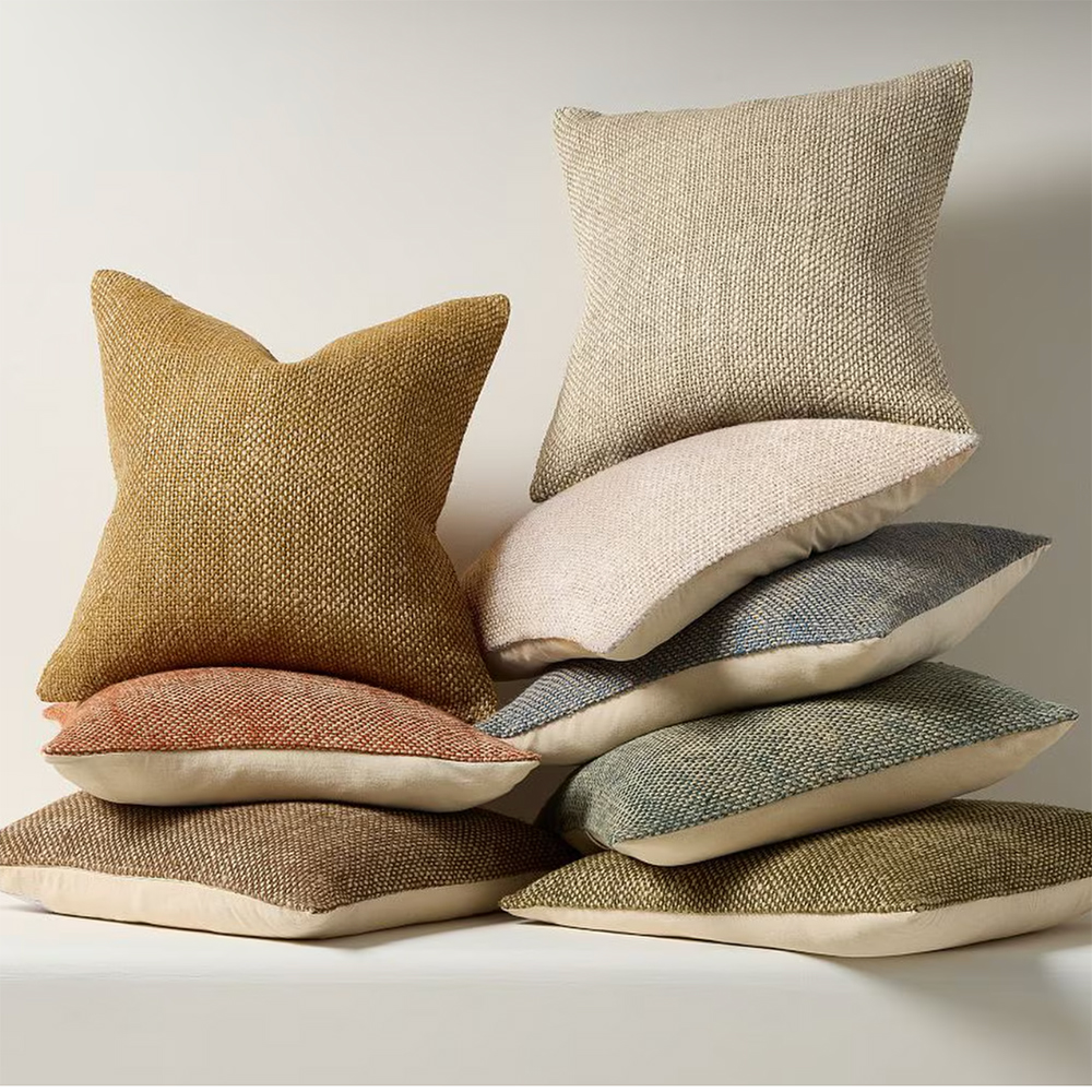 Soft shades of linen cushions in a pile