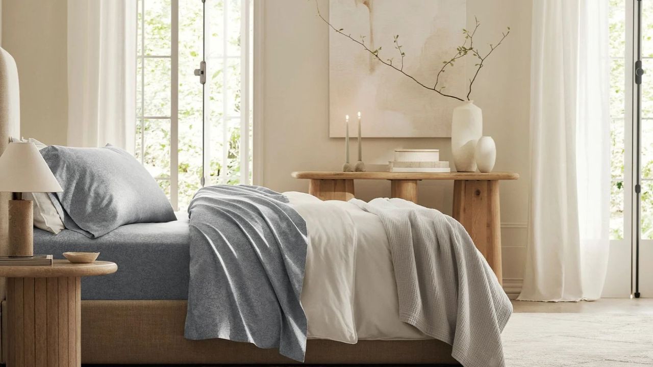 Side view of Boll &amp; Branch sheets on a bed against a cream wall.