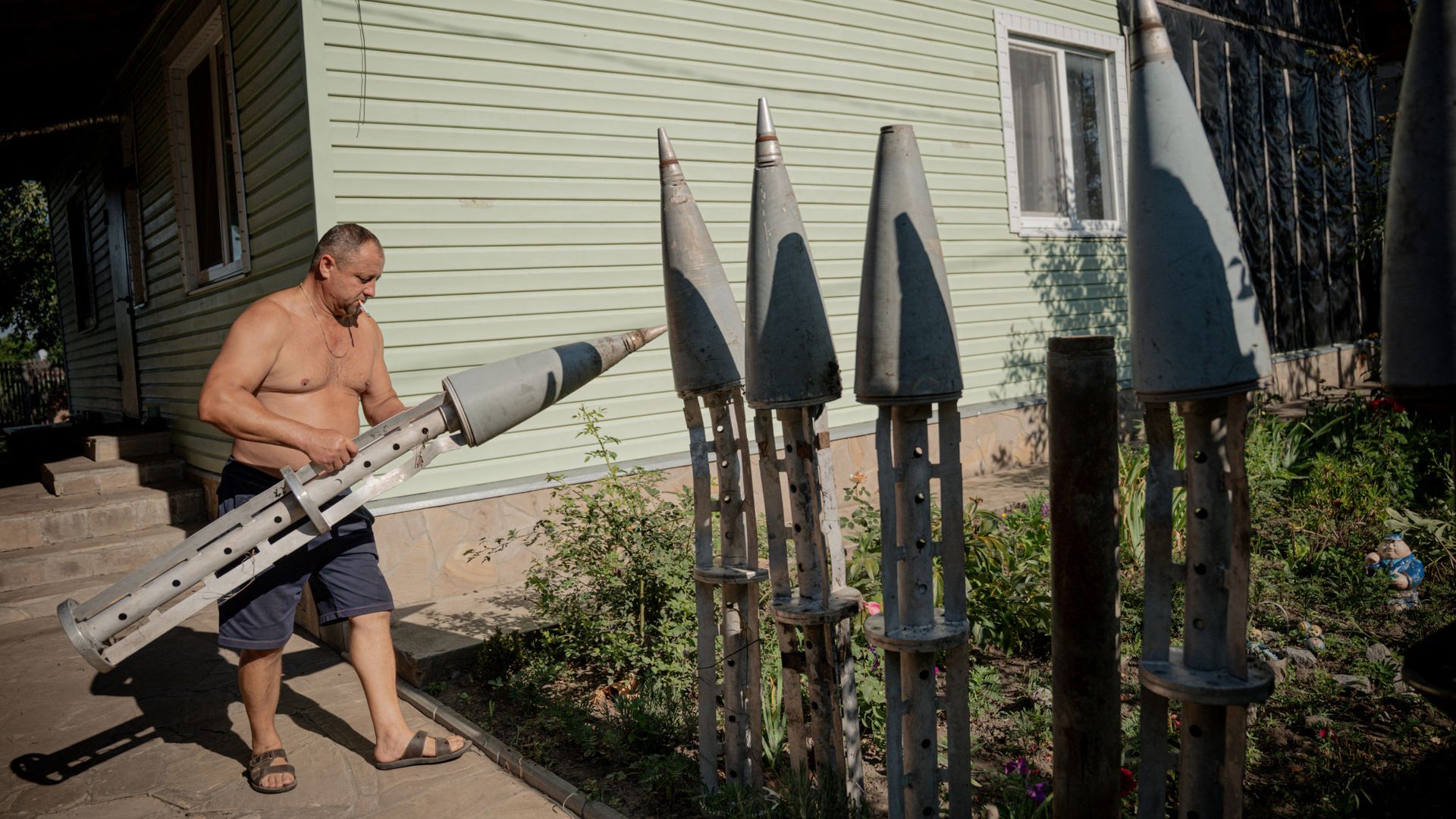 
                                A farmer collects missile fragments and places them in his garden in Ruski Tyshky, Ukraine
                            