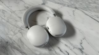 Sonos Ace headphones in soft white being worn on head