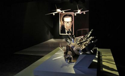 a David Altmejd sculpture, which sits in front of two Tom Sachs planes and Juergen Teller's portrait of Yves Saint Laurent