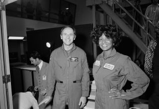 Actress Nichelle Nichols (Uhura in Star Trek) toured Johnson Space Center in Houston on March 4, 1977, while Apollo 12 lunar module pilot and Skylab II commander Alan Bean showed her what it felt like inside the Lower Body Negative Pressure Device and showed her how the Shuttle Procedures Simulator operated.