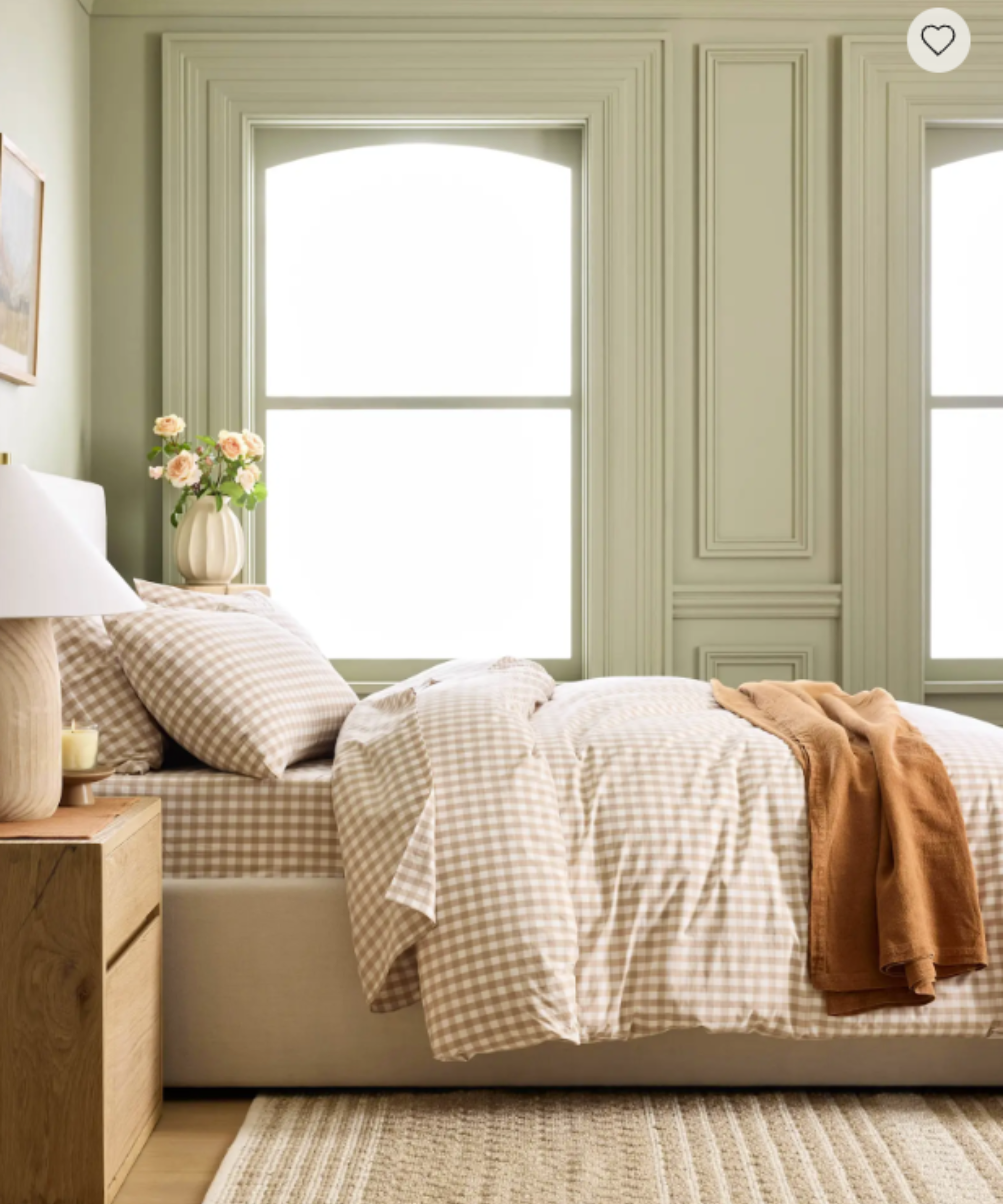 Quince gingham bed sheets styled inside a soft green bedroom with decorative molding