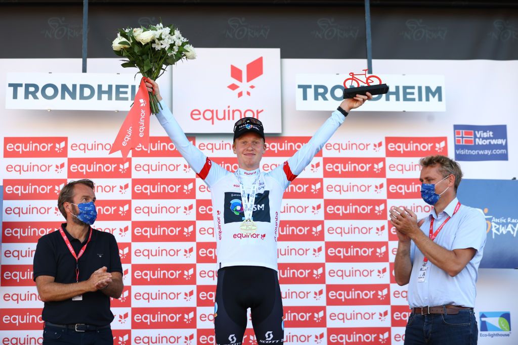 TRONDHEIM NORWAY AUGUST 14 Andreas Leknessund of Norway and Team DSM celebrates at podium as White Best Young Rider Jersey winner during the 9th Arctic Race Of Norway 2022 Stage 4 a 1591km stage from Trondheim to Trondheim ArcticRace on August 14 2022 in Trondheim Norway Photo by Michael SteeleGetty Images