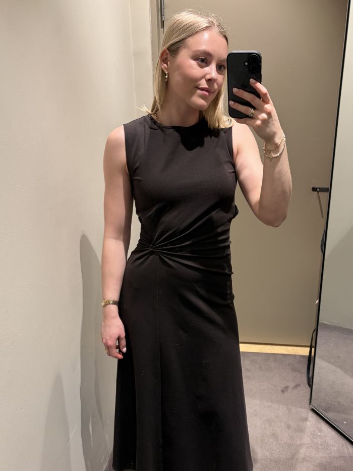 Woman wears brown twist-detail dress