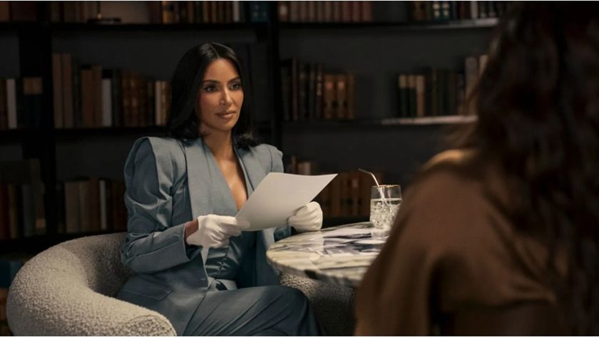 Stylishly-dressed attorney Allura (Kim Kardashian) sits across from a client in a book-lined room in a still from new legal drama All&#039;s Fair.