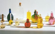 multiple multi-colour handblown glass bottles of skincare products by Kindred Black 