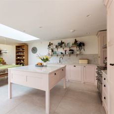 Pink kitchen cabinets with matching island