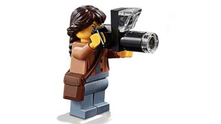 LEGO wildlife photographer with a camera and shoulder bag