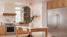 A modern, cream kitchen featuring a large, French door refrigerator from Frigidaire.