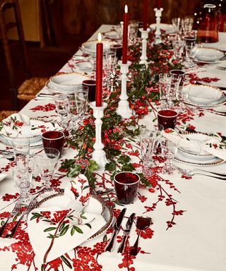 festive dining table with patterned tablecloth featuring a red foliage pattern